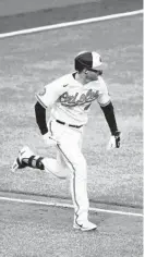  ?? JULIA NIKHINSON/AP ?? Orioles infielder Tyler Nevin, running to first base in the fifth inning Sunday, drove in a pair of runs in Baltimore’s 9-5 win over the Red Sox at Camden Yards.