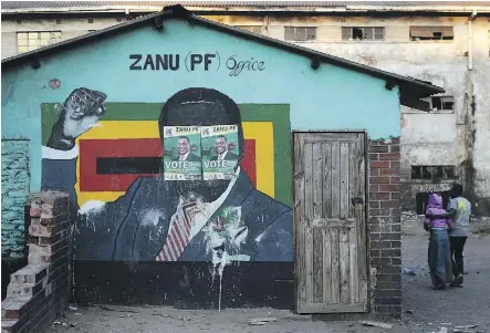  ?? DAN KITWOOD/GETTY IMAGES ?? Election posters in support of Zimbabwean President Emmerson Mnangagwa are pasted over a mural of former president Robert Mugabe in Harare. Mnangagwa hopes illegal wildcat gold mining now widespread in the country will boost the economy.