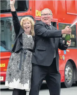  ?? Picture: NATIONAL LOTTERY/PA ?? Haul aboard... bus driver Kevin Jones and wife Michele celebratin­g yesterday