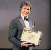  ?? VALERY HACHE/GETTY-AFP ?? Tom Cruise receives an honorary Palme d’Or on Wednesday at the Cannes Film Festival.