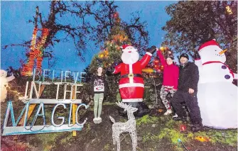  ??  ?? Kayden Hayes,12, and her parents, Shannon Hamill and Steve Hayes, keep the magic of a lavish Christmas lights display alive after a move to Saanich from Sooke.