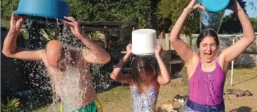  ??  ?? David, Viola and Tosca Stoloff each poured a bucket of cold water over their heads in their back yard. Photos: Supplied