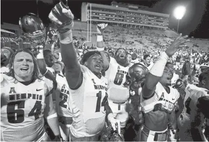  ?? THE COMMERCIAL APPEAL FILES ?? Sept. 12, 2015: Memphis teammates, from left, Zach Collins, Latarius Brady, Christophe­r Roberson and Arthur Maulet sing the university fight song after defeating Kansas 55-23 in Lawrence, Kansas.