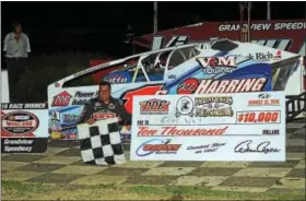  ?? SUBMITTED PHOTO - RICH KEPNER ?? Craig Von Dohren celebrates in victory lane with the $10,000 winner’s check after winning the Forrest Rogers Memorial on August 13 at Grandview.