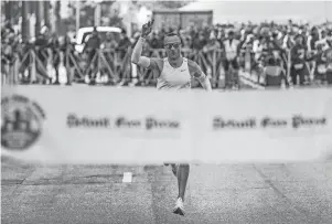  ?? RYAN GARZA/DFP ?? Ryan Corby, of Novi, approaches the finish line in first place for the men’s division of the full marathon during the 45th annual Detroit Free Press Marathon on Sunday.