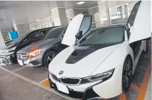  ?? SOMCHAI POOMLARD ?? Shown are some luxury cars seized from a call centre gang operating out of Phuket. The vehicles are being used as evidence in the police case after officers raided locations in Bangkok, Phuket, Nonthaburi and Chon Buri last week, during which they arrested a number of suspected gang members.