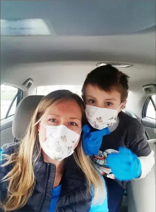  ?? Courtesy of Jessica Goeller ?? Mother Jessica Goeller, left, and her son, Lucas, wear masks and gloves to avoid the spread of COVID-19.