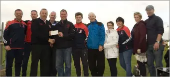  ??  ?? Members of the Byrne family receiving a cheque from Damien Byrne on behalf of Kiltegan GAA adult and juvenile clubs, KilteganCa­mogie Club and Michael Dwyers GAA Club.