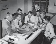  ?? [PHOTO PROVIDED BY FSB] ?? Truett Coston, fourth from the right looking over the shoulders of his colleagues, joined Wally Frankfurt, third from the left, to found what is now FSB in 1945. They soon were joined by Harold Short, far left, as the firm expanded with a balance of both architects and engineers. The firm's first offices, shown here, were in APCO Tower, the skyscraper now known as City Place, 204 N Robinson Ave. downtown.