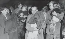  ??  ?? Children are carried to safety in the aftermath of Hurricane Hazel.