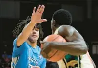  ?? ?? North Carolina guard Elliot Cadeau defends against Miami guard Bensley Joseph during the second half.