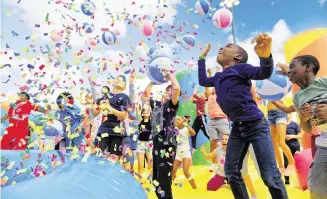  ?? ?? A confetti shower delights kids at The Big Bounce America, the world’s largest bounce house, coming to Miami in January.