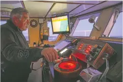  ??  ?? Pasquale Di Bartolomeo stands in the cockpit of his fishing trawler Marianna during a fishing trip in the Tyrrhenian Sea.