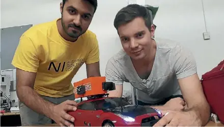  ??  ?? Waikato University’s Mikhail Sethi and Michael Redstall with their winning robot design.