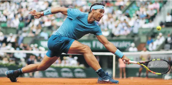  ?? GETTY IMAGES ?? Rafael Nadal reaches for a shot against Germany’s Maximilian Marterer on Monday at the French Open. The Spaniard’s win set the all-time record for match victories at majors.