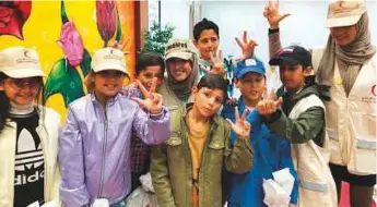  ?? Nora Jamal Sanad Al Suwaidi ?? Nora Jamal Sanad Al Suwaidi (right) and Danah Al Ali (centre) with some of the children at the Al Fhood Refugee Camp in Jordan. Below: Danah with one of the refugee children.