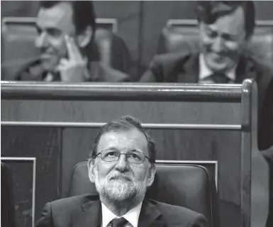  ?? Fotos: Francisco Seco, dpa ?? Mariano Rajoy sieht genervt aus, seine Parteikoll­egen lachen derweil.