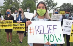  ?? SAUL LOEB/AFP VIA GETTY IMAGES ?? Aviation workers demonstrat­e on Capitol Hill in September, urging Congress to pass a COVID-19 relief package.