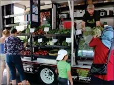  ?? PHOTO BY MICHILEA PATTERSON — FOR MEDIANEWS GROUP ?? People shop for fresh fruits and vegetable at a mobile market truck while it’s stopped near the Coventry Mall, which is right outside of Pottstown.