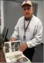  ?? DAN SOKIL — DIGITAL FIRST MEDIA ?? North Penn School District bus driver Jim Allebach looks through a photo album before departing on his final run delivering students on Thursday morning.