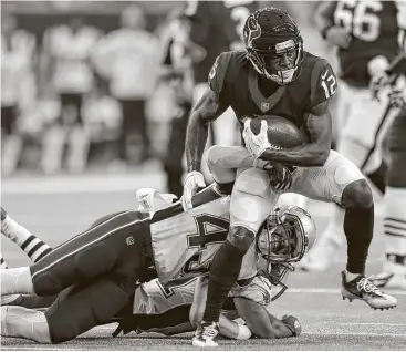  ?? Karen Warren / Houston Chronicle ?? Bruce Ellington (12) picks up extra yardage after a reception against the Patriots, helping the recent addition to the Texans’ depleted receiving corps gain ground in a bid to make the team.