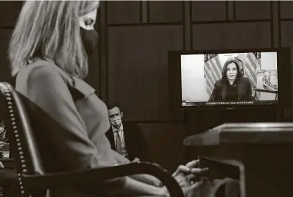  ?? Leah Millis / Associated Press ?? Democratic vice presidenti­al candidate Sen. Kamala Harris, D-Calif., speaks from her office during the Judiciary Committee confirmati­on hearings for Supreme Court nominee Amy Coney Barrett, left, on Capitol Hill.