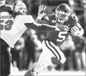  ?? Special to NWA Democrat-Gazette/DAVID BEACH ?? Arkansas Junior Rakeem Boyd (5) runs away from Western Kentucky’s Jeremy Darvin (53) during the fourth quarter Nov. 9 at Reynolds Razorback Stadium in Fayettevil­le.