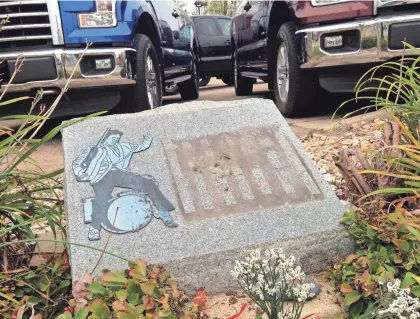  ??  ?? A descriptiv­e metal plate has been torn from the stone marker showing where Elvis Presley stopped a fight at a Madison service station in 1977. The marker was installed 10 years ago by Suburban Wheels of Madison, now Schoepp Motors Northeast, 1518 N....