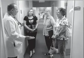  ?? SUBMITTED PHOTO ?? Elaine Reynolds, Women’s Leadership Council Steering Committee member, Marian Bruemmer, and Christine Mulcahey, executive director of Health Partners, talk with Dr. Atonino Barbaro, Health Partners dentist, to discuss a recent grant that will enable...