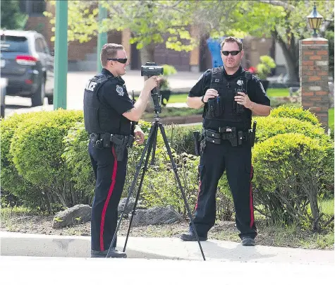  ?? BRANDON HARDER ?? Regina Police Service officers operate a speed trap at the corner of University Park Drive and Brodie Bay.