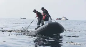  ?? Achmad Ibrahim, The Associated Press ?? Rescuers conduct a search operation in the waters of West Java, Indonesia, after a Lion Air plane crashed into the sea Monday.