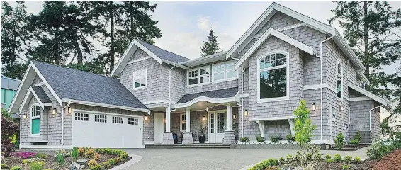  ??  ?? A laid back, coastal look is evident inside and out. The exterior is clad in cedar shingles with a transparen­t stain that will weather over the years.