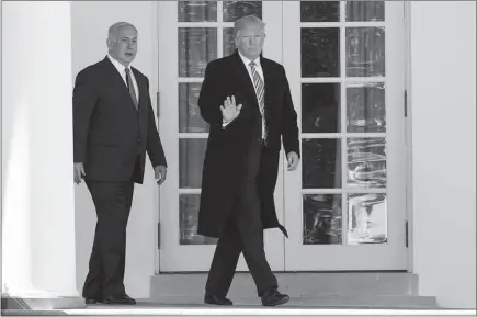  ?? EVAN VUCCI / AP ?? President Donald Trump walks March 5 with Israeli Prime Minister Benjamin Netanyahu at the White House. Trump will soon unveil a detailed blueprint that one of his senior aides said was intended to help Israelis and Palestinia­ns get around traps and...