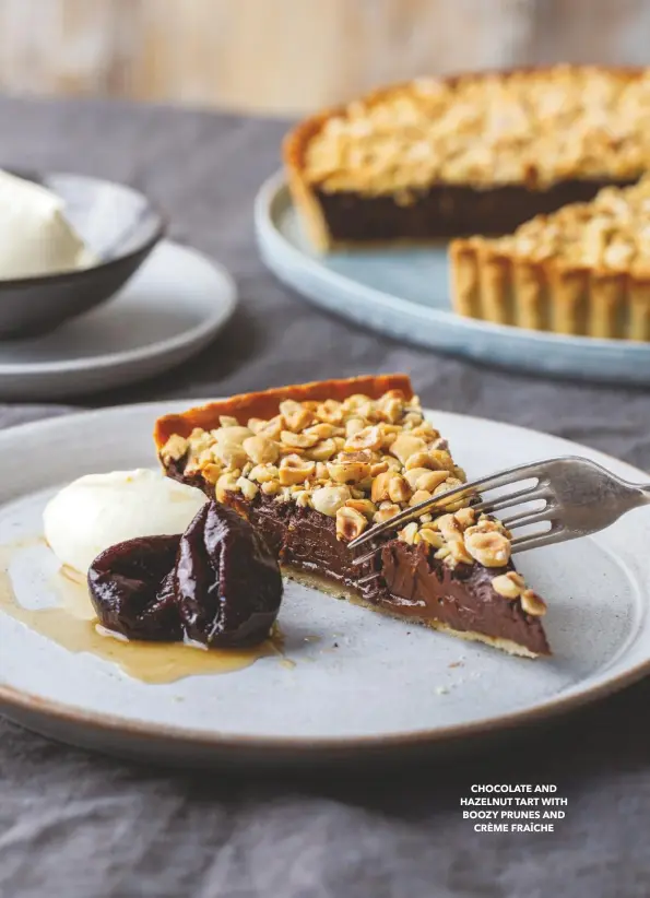  ??  ?? CHOCOLATE AND HAZELNUT TART WITH BOOZY PRUNES AND CRÈME FRAÎCHE