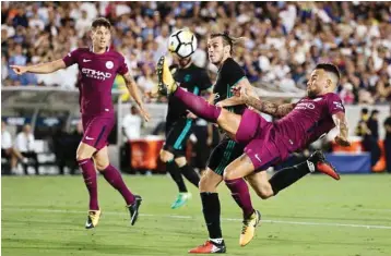  ?? PIC/AP/PTI ?? Manchester City’s Nicolas Otamendi kicks the ball away from Real Madrid’s Gareth Bale