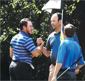  ??  ?? David Stewart, right, is the 2018 Scotia Wealth Open men’s golf champion played at Nipawin’s Evergreen Golf Course. Here, he received congratula­tions from former champion Justin Wood..