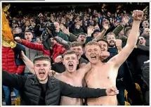  ??  ?? Wolves supporters celebrate their team’s win over Manchester United in the FA Cup quarterfin­als.