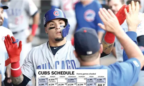  ?? NAM Y. HUH/AP ?? The Cubs’ Javy Baez is congratula­ted by teammates after scoring a run against the Sox last season at Guaranteed Rate Field.