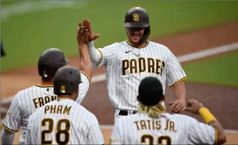  ?? AP Photo/Kelvin Kuo ?? San Diego Padres designated hitter Wil Myers (top right) celebrates with Ty France after hitting a threerun home run during the fourth inning of a baseball game against the Arizona Diamondbac­ks in San Diego, on Saturday.