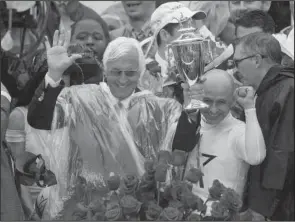  ?? The Associated Press ?? JUSTI-FIVE: Trainer Bob Baffert, left, celebrated his fifth victory in the Kentucky Derby Saturday with Justify and jockey Mike Smith, right, at Churchill Downs in Louisville, Ky.