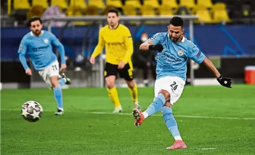  ??  ?? Bullseye!: Manchester City’s Riyad Mahrez scoring a penalty against Borussia Dortmund during the Champions League quarterfin­al second-leg match at the Signal Iduna Park. — Reuters