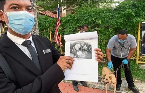  ??  ?? Court exhibits: Roziman, with the dog outside the court complex, showing a picture of it when it was found in the empty house.