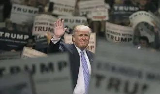  ??  ?? Republican presidenti­al candidate Donald Trump waves to the crowd Wednesday as he arrives at a rally at the Anaheim Convention Center in California.