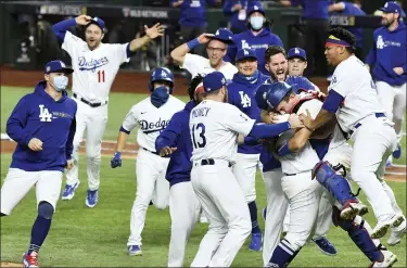  ?? WALLY SKALIJ — THE ASSOCIATED PRESS ?? The Los Angeles Dodgers celebrate winning their first World Series championsh­ip in 32 years in Arlington, Texas, Tuesday.