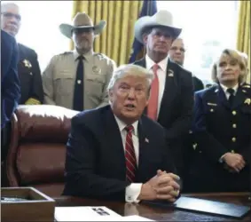  ?? EVAN VUCCI—ASSOCIATED PRESS ?? In this March 15, 2019, photo, President Donald Trump speaks about border security in the Oval Office of the White House, Friday, March 15, 2019, in Washington. Trump’s veto of a bipartisan congressio­nal resolution rejecting his border emergency declaratio­n is more than a milestone. It signals a new era of tenser relations between the two ends of Pennsylvan­ia Avenue.