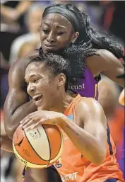  ?? Jessica Hill Associated Press ?? THE SPARKS’ Chiney Ogwumike defends the Sun’s Alyssa Thomas, who had 22 points and 10 rebounds.