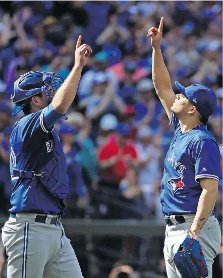  ?? — THE ASSOCIATED PRESS ?? Fans from across Western Canada were cheering in the stands in Seattle as Toronto Blue Jays teammates Luke Maile and Roberto Osuna celebrated Sunday’s 4-0 win over the Mariners.