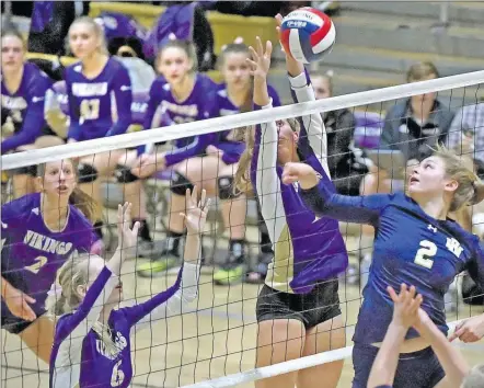  ?? Signal File Photo ?? West Ranch’s Katie Jacobs (2), right, tips the ball over the net against Valencia’s Lauryn Shockley (11), center, and Hannah Weltmann (6) last season. Shockley will play a valuable role for the Vikings this year.