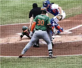  ?? CYNDI CHAMBERS
For the Miami Herald ?? Yohandy Morales scores a run for the Miami Hurricanes in the first inning of the game against the Florida Gators at the Florida Ballpark in Gainesvill­e on Feb. 21.