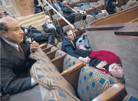  ?? TOM WILLIAMS/CQ-ROLL CALL ?? Rep. Jason Crow, center, comforts Rep. Susan Wild while taking cover as a mob of Trump supporters breaks into the U.S. Capitol on Jan. 6.